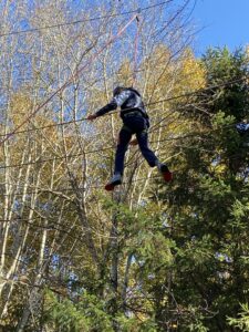 Teenager crossing a tightrope challenge.