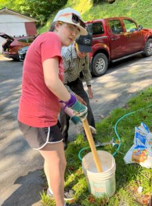 Evelyn and Barrett mix concrete.